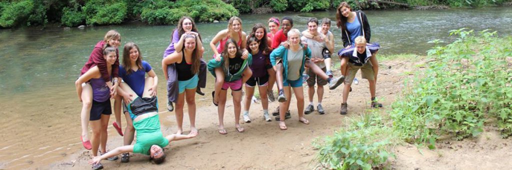 high school theater camp outdoors posing by the water