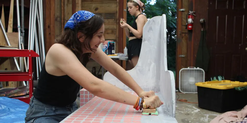 Teenage girls designing a set